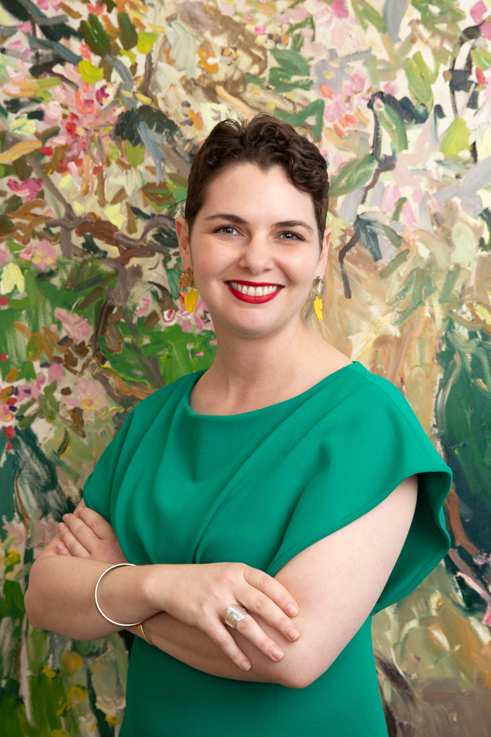 Photograph of Amanda Strauss in front of a painting